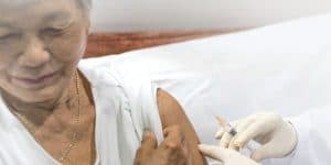 Old woman taking shringle vaccine